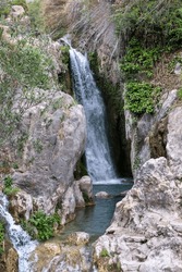 Secluded Waterfall Cascades Into A Serene Rock Pool, A Hidden Gem Tucked Away In A Lush Spain Mountain Ravine. High Quality Photo