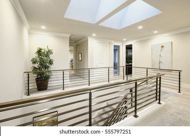 Second floor landing features skylight over the staircase with metal horizontal railings. Northwest, USA