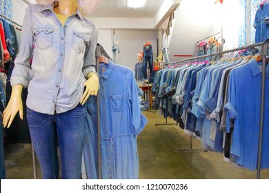 At The Second Hand Clothes Shop, Many Jeans Shirt And Trousers Are Hanging On The Clothes Line.