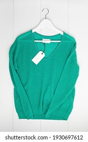 Second hand wardrobe idea. Circular fshion, eco friendly sustainable shopping, thrifting shop concept. Top view over pullover with tag mockup. - Shutterstock ID 1930697612