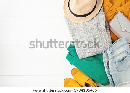 Second hand wardrobe idea. Circular fashion, eco friendly sustainable shopping, thrifting shop concept. Top view over woman outfit.