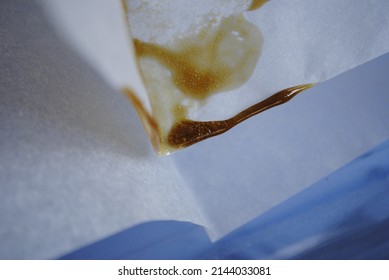 The Second Press Of Cannabis Marijuana Keif Through A Heated Hydraulic Press. Making Weed Hash Oil Rosin From Trichomes Of Pot Plant.