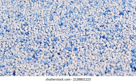 Secondary Granule Made Of Polypropylene, Blue Plastic Pellets Crumbles To The Table. Plastic Raw Materials In Granules For Industry. Polymer Resin. Raw Plastic Recycling Concept