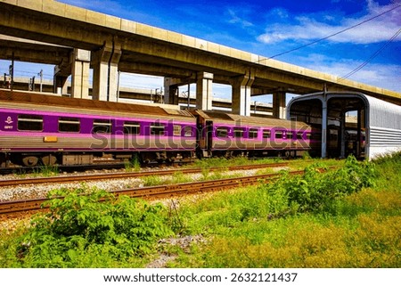 A second-class air-conditioned sleeper coach by Daewoo seen at the LD shunting yard near Krung Thep Aphiwat Central Terminal (Bang Sue Grand Station) in Bangkok, Thailand. The scene captures the opera