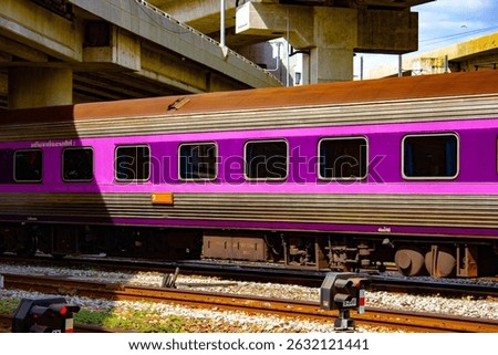 A second-class air-conditioned sleeper coach by Daewoo seen at the LD shunting yard near Krung Thep Aphiwat Central Terminal (Bang Sue Grand Station) in Bangkok, Thailand. The scene captures the opera