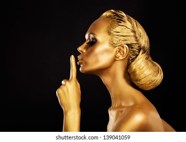 Secrecy. Bodyart. Golden Woman showing Silence Sign. Hush!