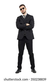 Secret Agent Or Bodyguard With Crossed Arms Looking At Camera. Full Body Length Portrait Isolated Over White Studio Background.