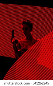 Secret Agent Spy Silhouette In Light Painting  Backdrop - Retro Tough Woman With Gun In Red Lights Composition
