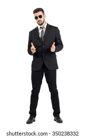 Secret Agent With Sunglasses Aiming Hand Gun Gesture At Camera. Full Body Length Portrait Isolated Over White Studio Background.