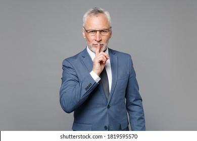 Secret Elderly Gray-haired Bearded Business Man In Blue Suit Shirt Tie Isolated On Grey Background. Achievement Career Wealth Business Concept. Saying Hush Be Quiet With Finger On Lips Shhh Gesture