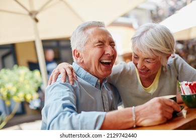 The secret to a happy marriage Live, laugh and love. Shot of a senior couple having coffee at a cafe. - Powered by Shutterstock