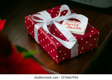 Secret Santa Concept - Wrapped Present On Work Desk, Copy Space