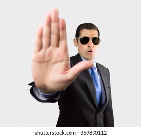 Secret Service Agent With Open Palm Gesturing To Stop Us Isolated On White Background