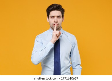 Secret Young Business Man In Classic Blue Shirt Tie Isolated On Yellow Background. Achievement Career Wealth Business Concept. Mock Up Copy Space. Say Hush Be Quiet With Finger On Lips Shhh Gesture