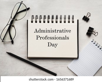 Secretaries Day And Admin Day. Greeting Card. Close-up, View From Above, Wooden Surface. Concept Of Preparation For A Professional Holiday. Congratulations For Relatives, Friends And Colleagues.
