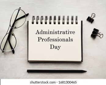 Secretaries Day and Admin Day. Greeting card. Close-up, view from above, wooden surface. Concept of preparation for a professional holiday. Congratulations for relatives, friends and colleagues.