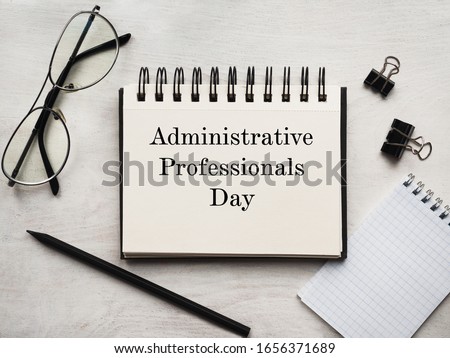 Secretaries Day and Admin Day. Greeting card. Close-up, view from above, wooden surface. Concept of preparation for a professional holiday. Congratulations for relatives, friends and colleagues.