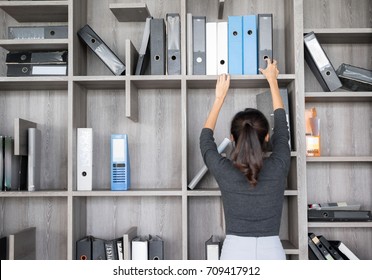 Secretary Or Purchasing Manager  In A Modern Office Shelves Room. Setup Studio Shooting.