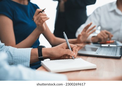 Secretary taking notes on notebook at corporate meeting with group of multiracial business people discussing together in meeting room. Diversity in professional meeting at modern office. Concord - Powered by Shutterstock