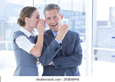 Secretive Business Colleagues Whispering In The Office