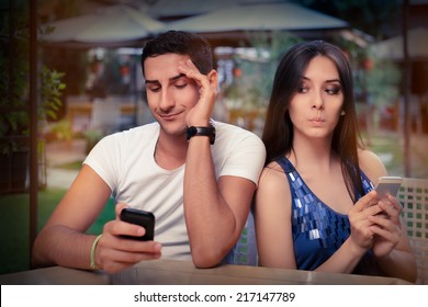 Secretive Couple with Smart Phones in Their Hands - Young adult couple has privacy problems with modern technology 