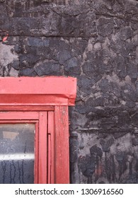                               Section of a building facade with red window frame