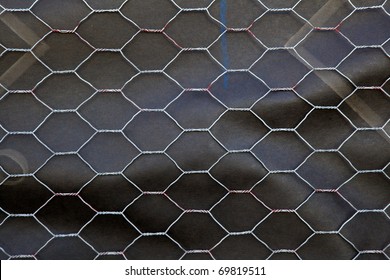 Section of Chicken wire over black roofing paper