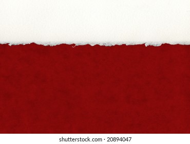 A Section Of Deckled Edge Paper On A Red Background.