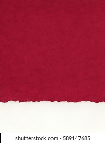 A Section Of Deckled Edge Paper On A Textured Red Background.