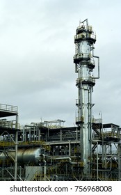 Section Of The Distillery Plant Of A Modern Oil Refinery With A Fractionating Column, Tanks And Pipelines