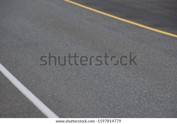 section of dry\
asphalt road with road\
markings