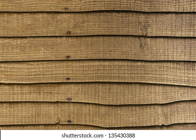 A Section Of Horizontal, Overlapped Wooden Garden Fencing.