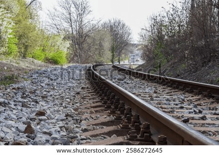 a section of railway with two tracks running through a scenic area.