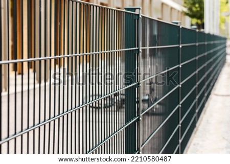 Sectional metal Mesh Fence. Steel grating fence. Sectional fencing installation. 