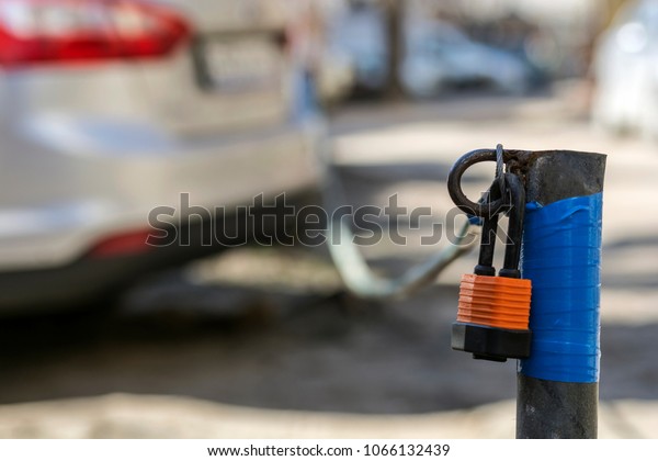 Secure car\
parking with a tensioned cable with a\
lock