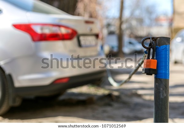 Secure car\
parking with a tensioned cable with a\
lock