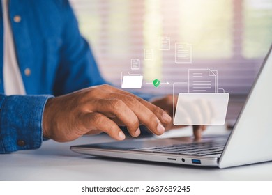 Secure cloud data storage concept, Businessman using laptop with digital folders and documents, illustrating online file management, cybersecurity, and safe digital document organization solutions