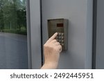 Secure Home System, Hand Pressing on Intercom Keypad, Using Door Phone, Doorphone, Entryphone, Videophone Call, Digital Electronic Doorbell