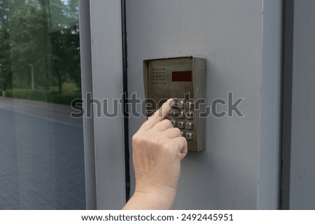Secure Home System, Hand Pressing on Intercom Keypad, Using Door Phone, Doorphone, Entryphone, Videophone Call, Digital Electronic Doorbell