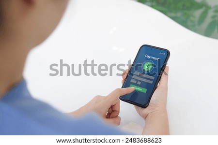 Secure Online Payment Transaction Process concept. Person confirming a secure online payment using a credit card through a digital interface with verification tick symbol. Internet banking, fintech,