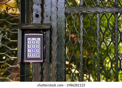 Secure password on keyboard for opening door. Metal code combination lock. Background of trees in the park.