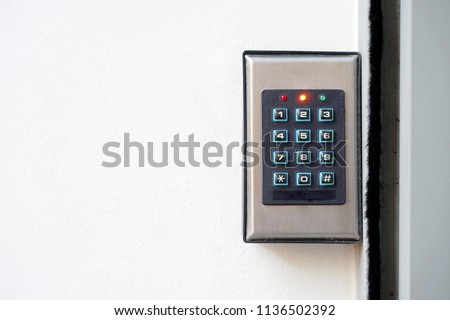 Secure password on keyboard for opening home house door. Password code Security keypad system protected in Public Building. The security code combination to unlock the door