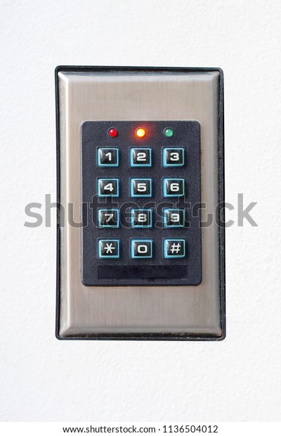 Secure\
password on keyboard for opening home house door. Isolated.\
Password code Security keypad system protected in Public Building.\
The security code combination to unlock the\
door