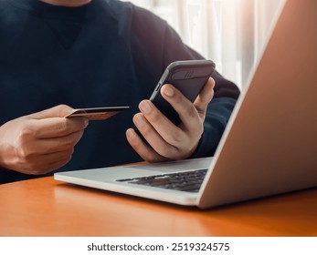 Secure payment concept. Black smart mobile smart phone in businessman hand while holding credit card for checking payment, online shopping, exchange or money transfer by finance application. - Powered by Shutterstock