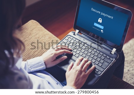 Secure payment on the screen. Hands over the keyboard on laptop.