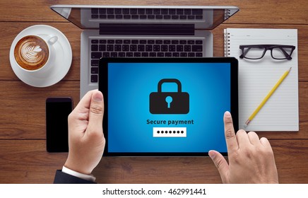 Secure payment, on the tablet pc screen held by businessman hands - online, top view