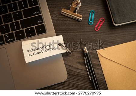 Secure technology and Passwordless Authentication on word card with clips, laptop, pen. Cyber security, protection and digital trust.