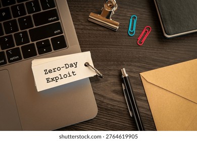 Secure technology and Zero-Day Exploit on word card with laptop, pen, clips. Cyber security, protection and digital trust.