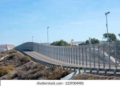 The secured border fence and road for United States border patrol vehicles on the US - Mexico international border in California