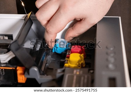 securing blue ink tank in printer during maintenance process for optimal functionality